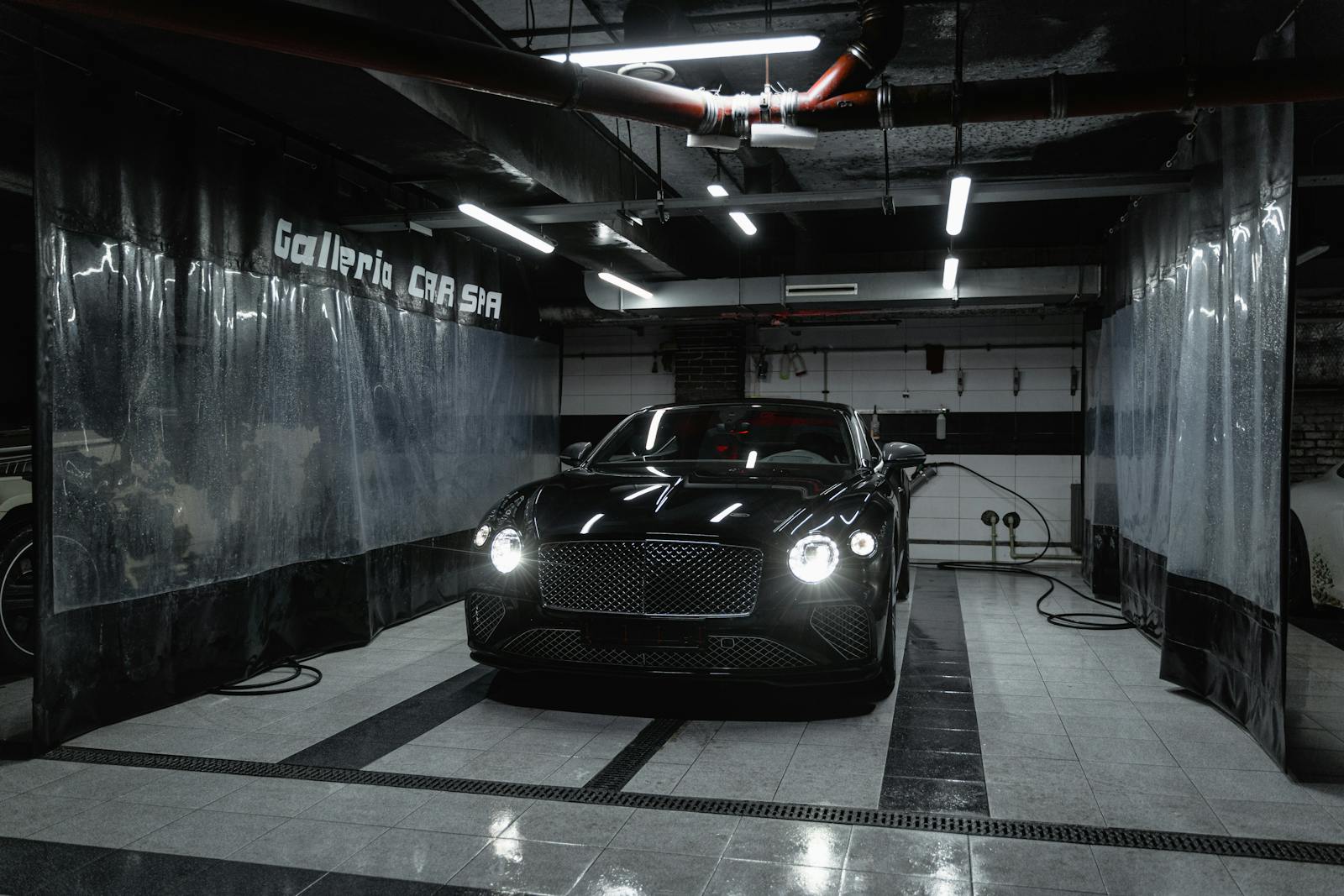 A Black Car Parked in the Carwash Garage