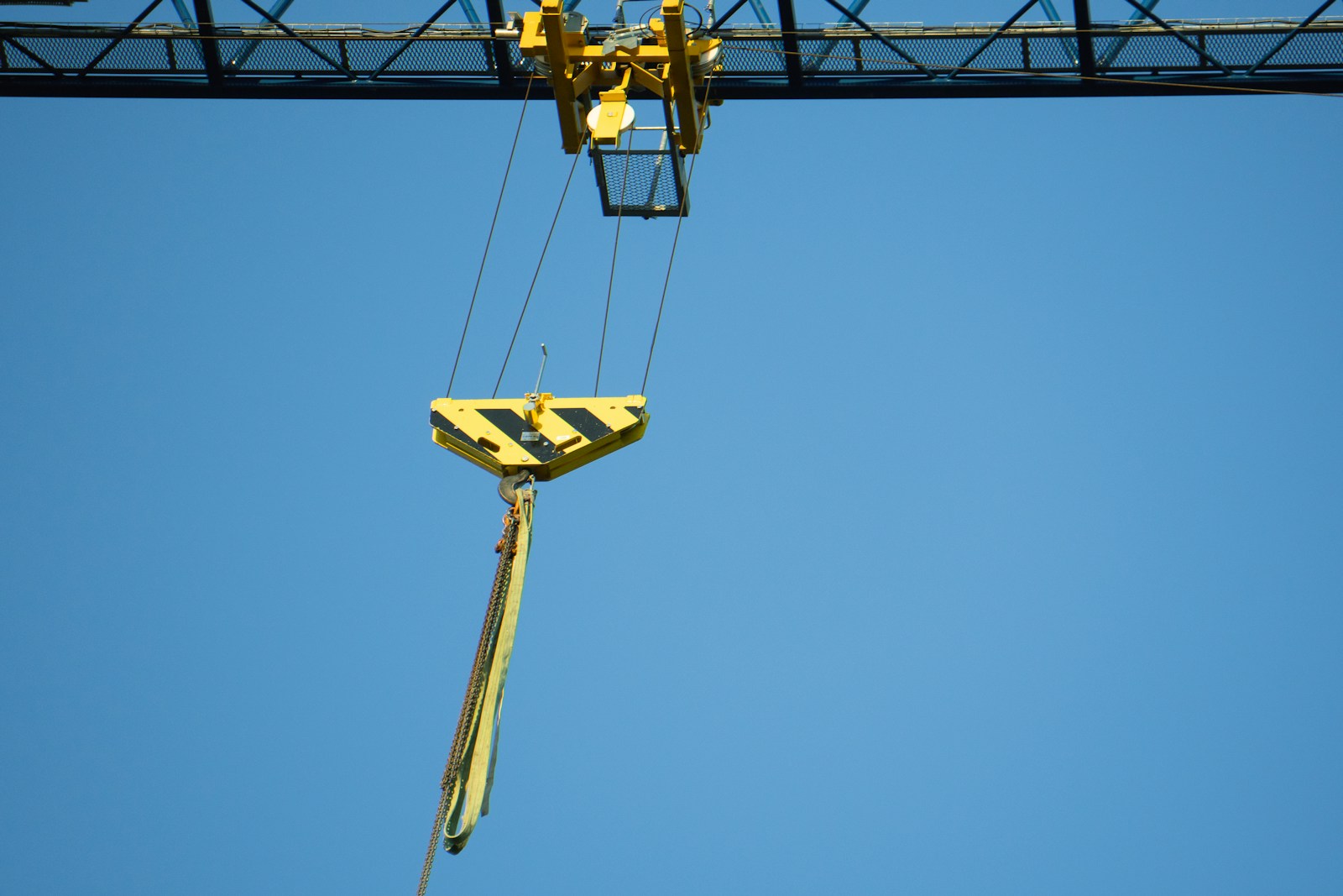 a crane is lifting a piece of equipment into the air