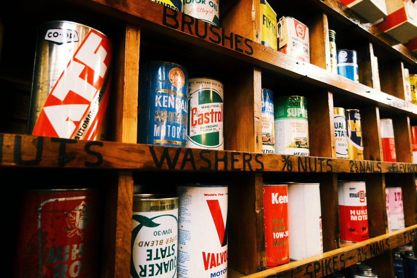 Shelves stocked with vintage cans of paint and hardware.